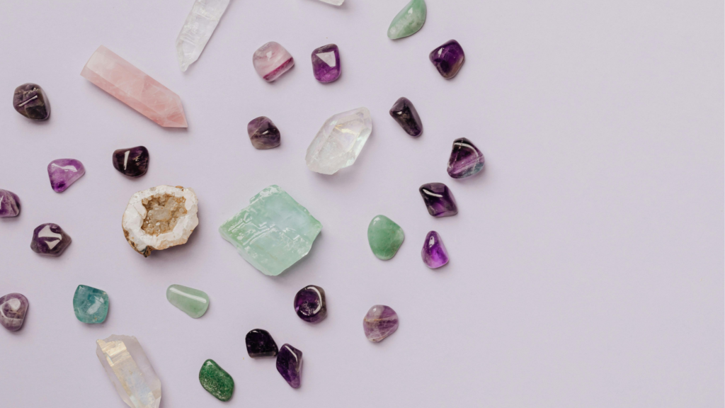 Multi coloured healing crystals on a white background