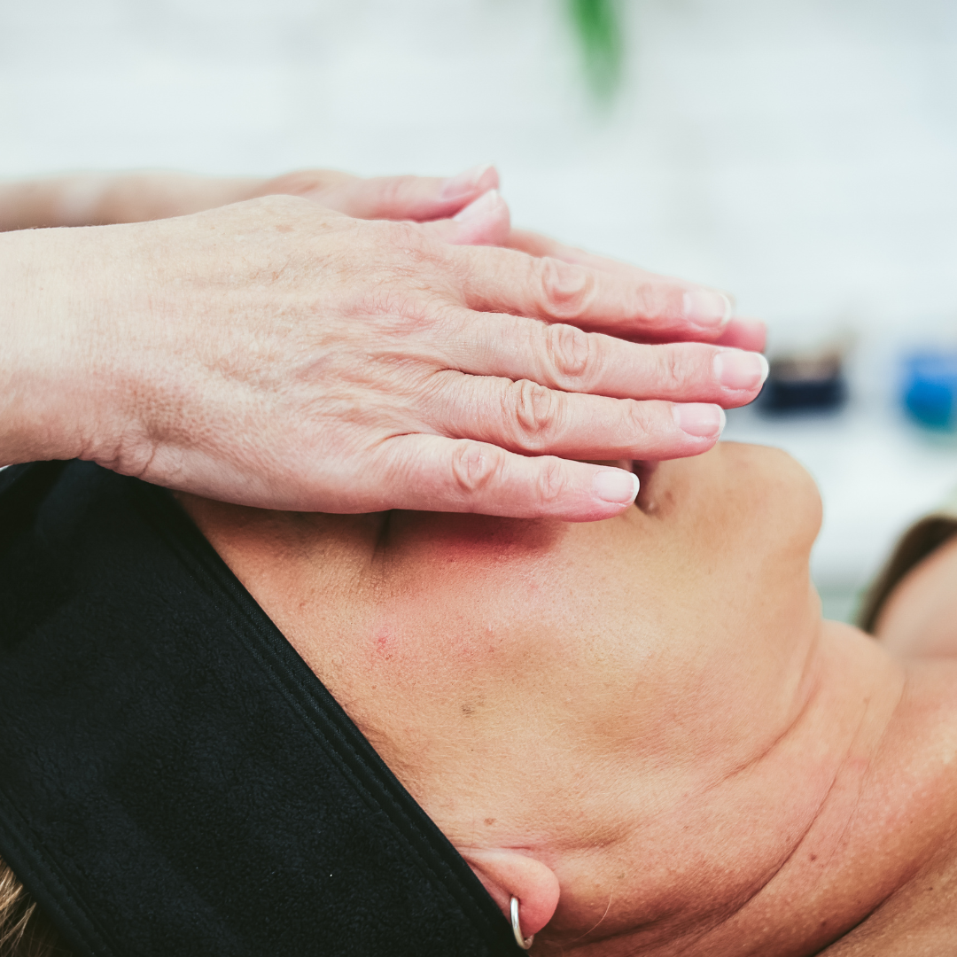 a person's hands covering a woman's face