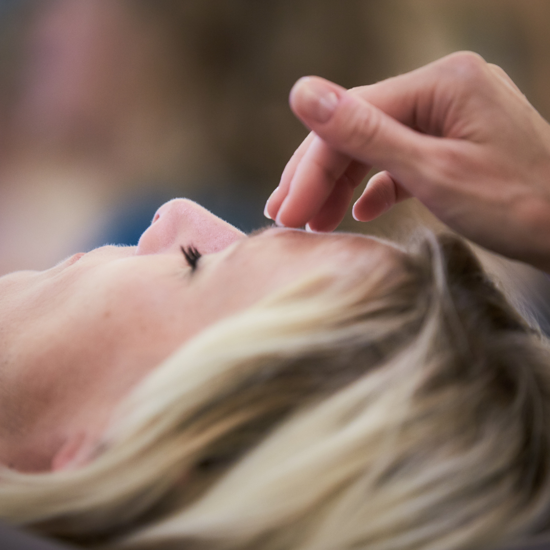 a person touching a woman's face